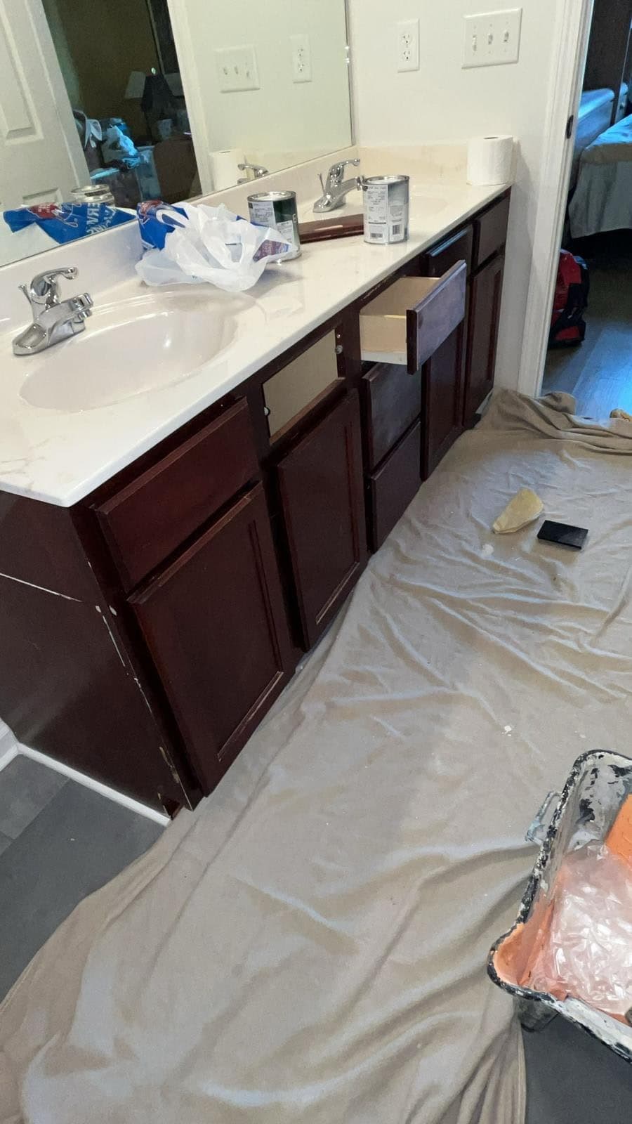Master bathroom vanity with dated cherry-stained cabinet doors before refinishing by Drywall & Remodeling ETC. in Memphis, TN